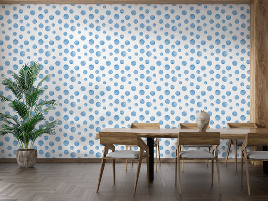 Dining room with wooden table and watercolor blue seamless design polka dots wallpaper.