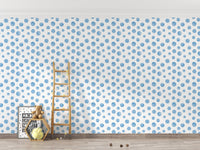 Kids room with a wooden ladder against a blue dotted wallpaper