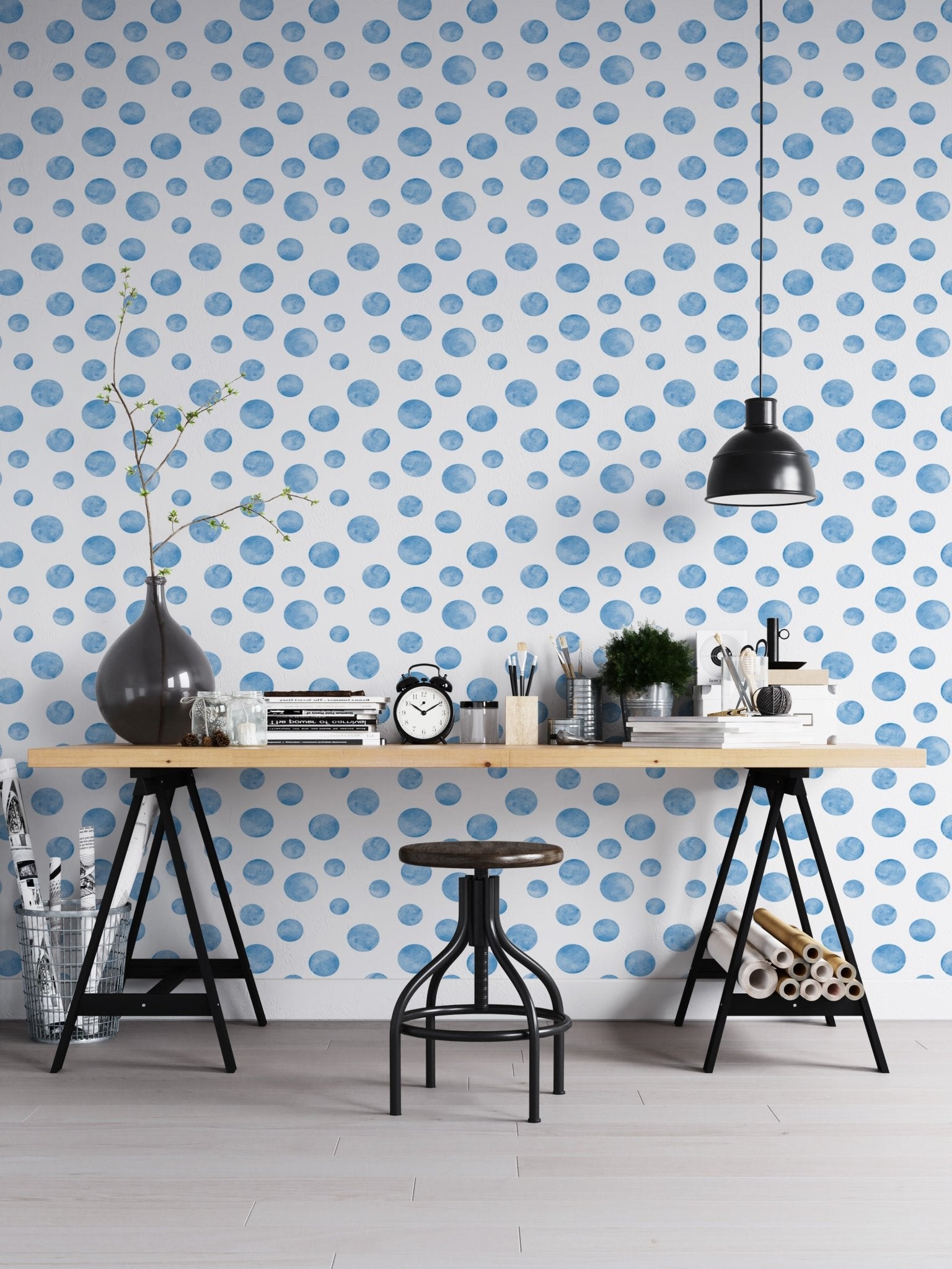 Workspace with a black desk and watercolor blue seamless design wallpaper.