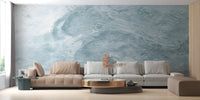 Textural blue wave wall mural in a minimalist room with a brown sofa.