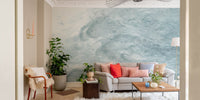 Modern abstract wall mural with blue watercolor swirls in a living space.