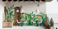 Cafe interior with green botanical wall mural and small dining sets.