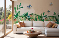 Modern living area with lush botanical leaf wall mural and white sectional.