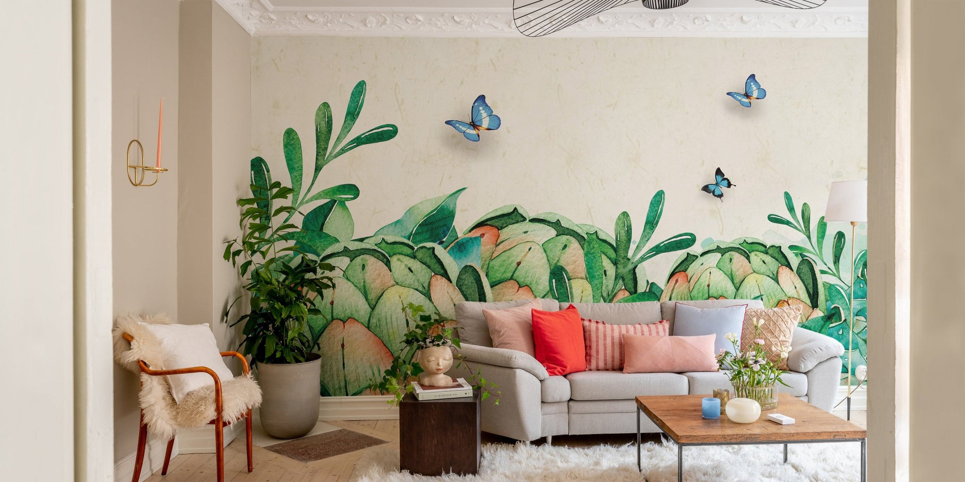 Living room featuring watercolor greenery wall mural and grey sofa.