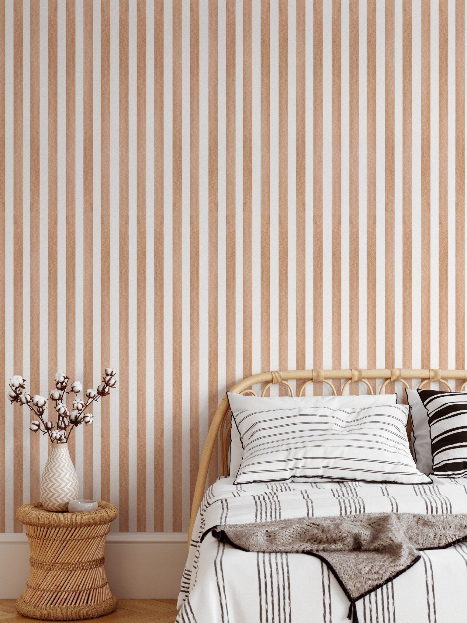 Watercolor brown striped wallpaper behind a single bed in bedroom.