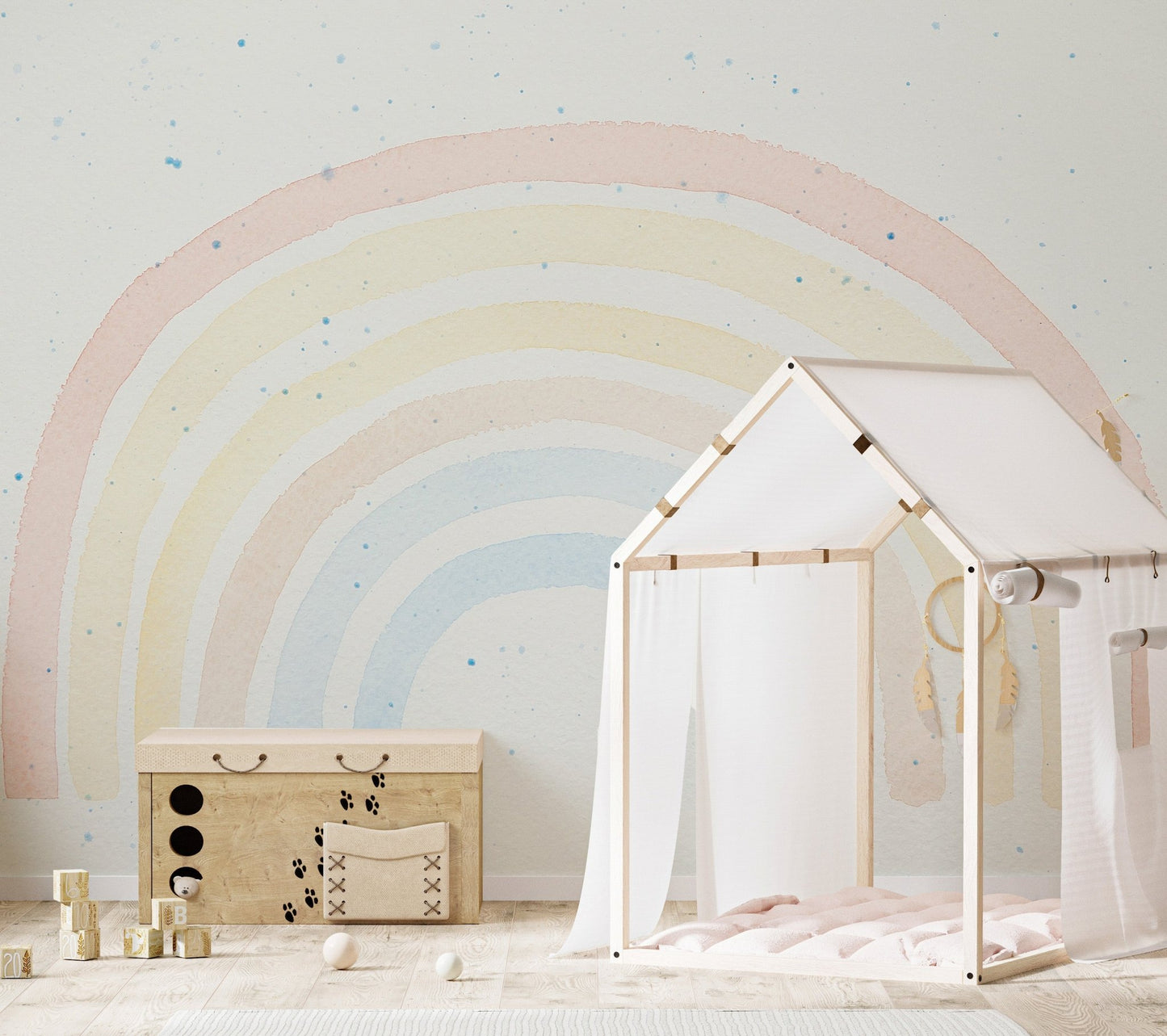 Pastel rainbow design wall mural behind white wooden play house for children