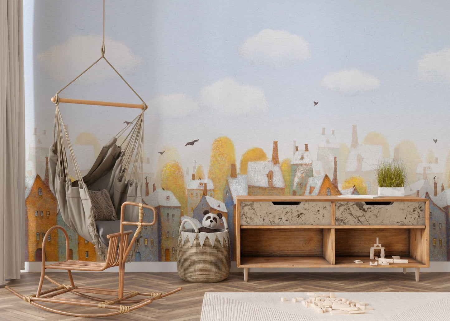 Minimalist nursery with a watercolor city wall mural in shades of blue and gold.