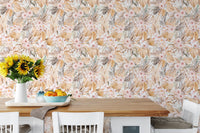 Tropical botanical wallpaper behind wooden dining table with sunflowers and fruit