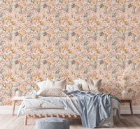 Dried leaf pattern wallpaper in bedroom with light linens and grey pillows