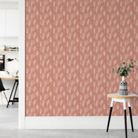 Workspace wall with terracotta pampas grass wallpaper and white furniture.