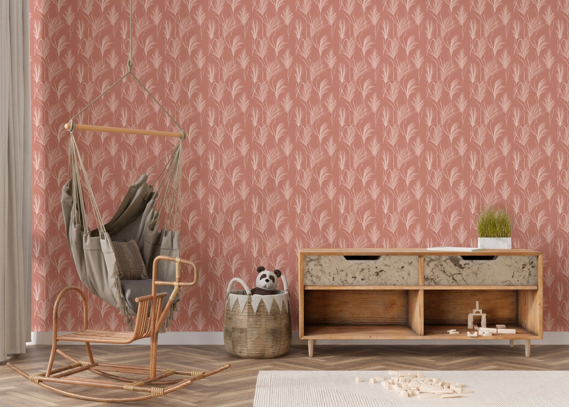 Nursery area with terracotta boho wallpaper mural and a wooden sideboard.