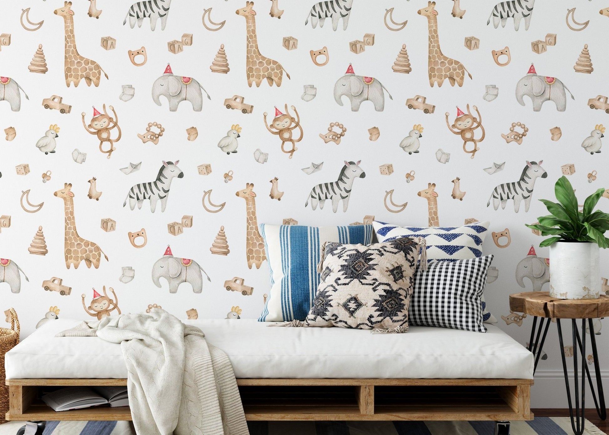 Animal pattern wallpaper behind a daybed with blue and white pillows.
