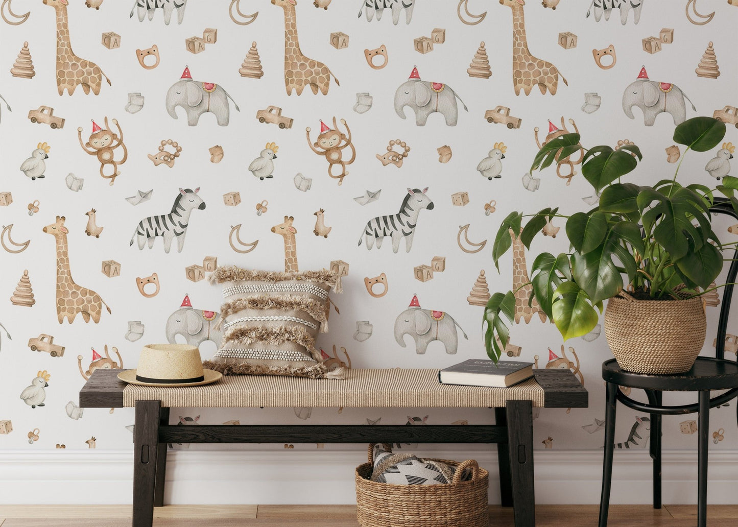 Safari wallpaper with monkeys and giraffes behind a bench and black chair.