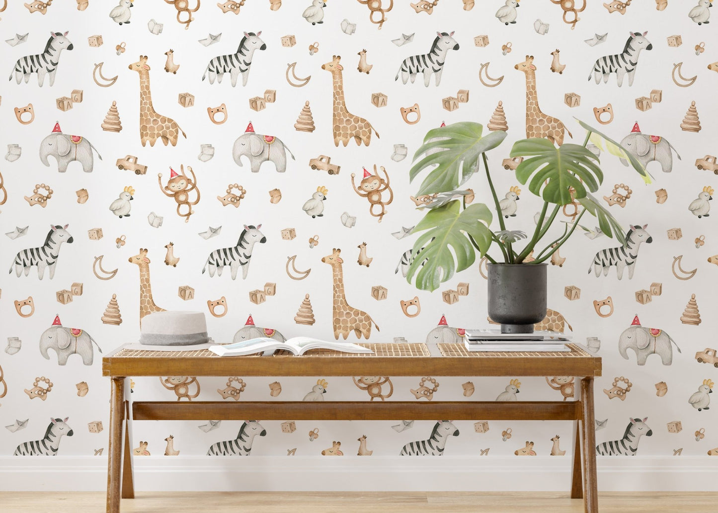 Watercolor safari animals wallpaper behind a wooden bench and green potted plant.