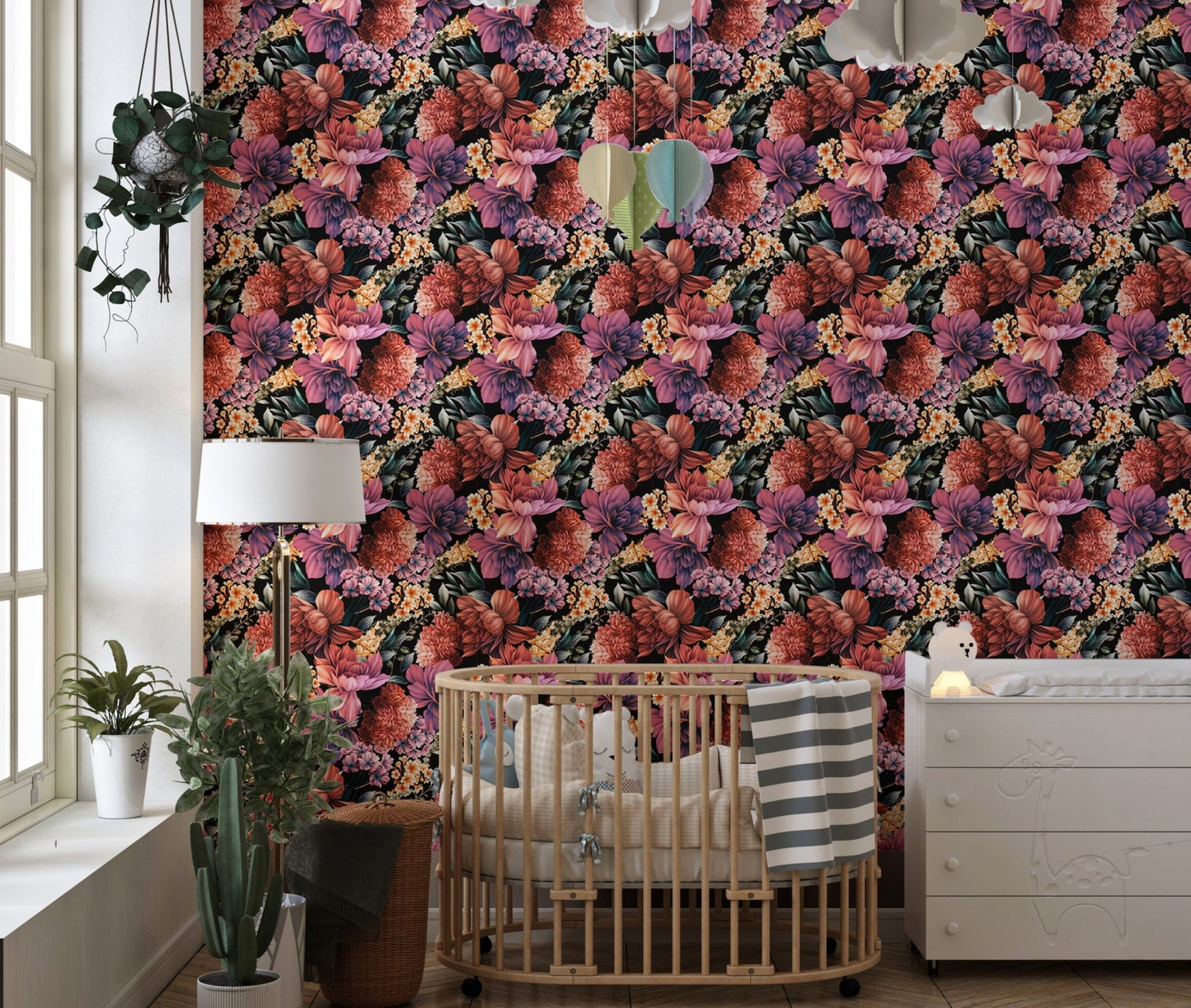 Summer floral wallpaper in a nursery with a wooden crib and white dresser.