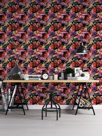 Flower wallpaper on an office wall behind a large desk with stationery and lamp.