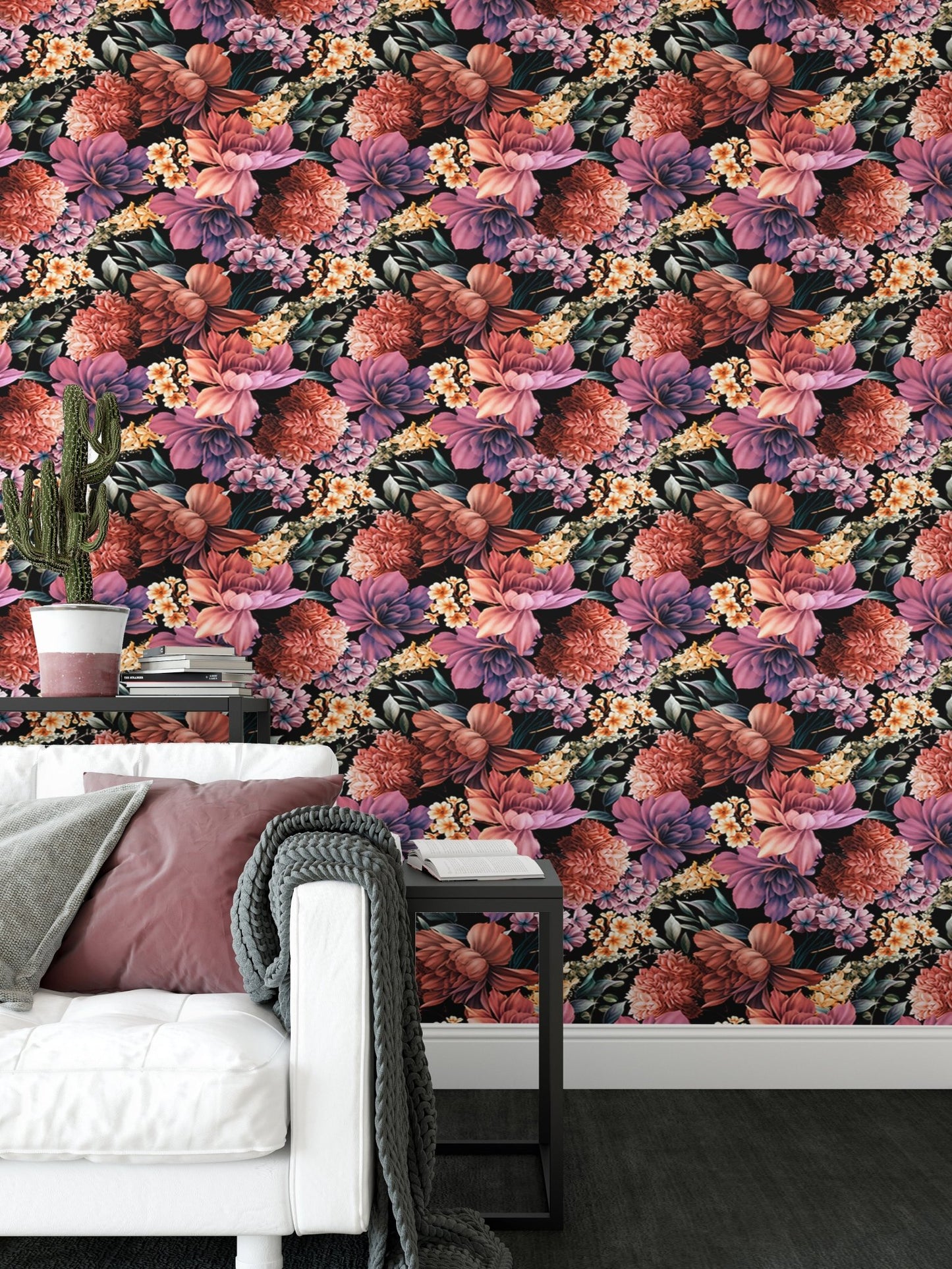 Patterned flower wallpaper behind a white sofa with grey and pink cushions.