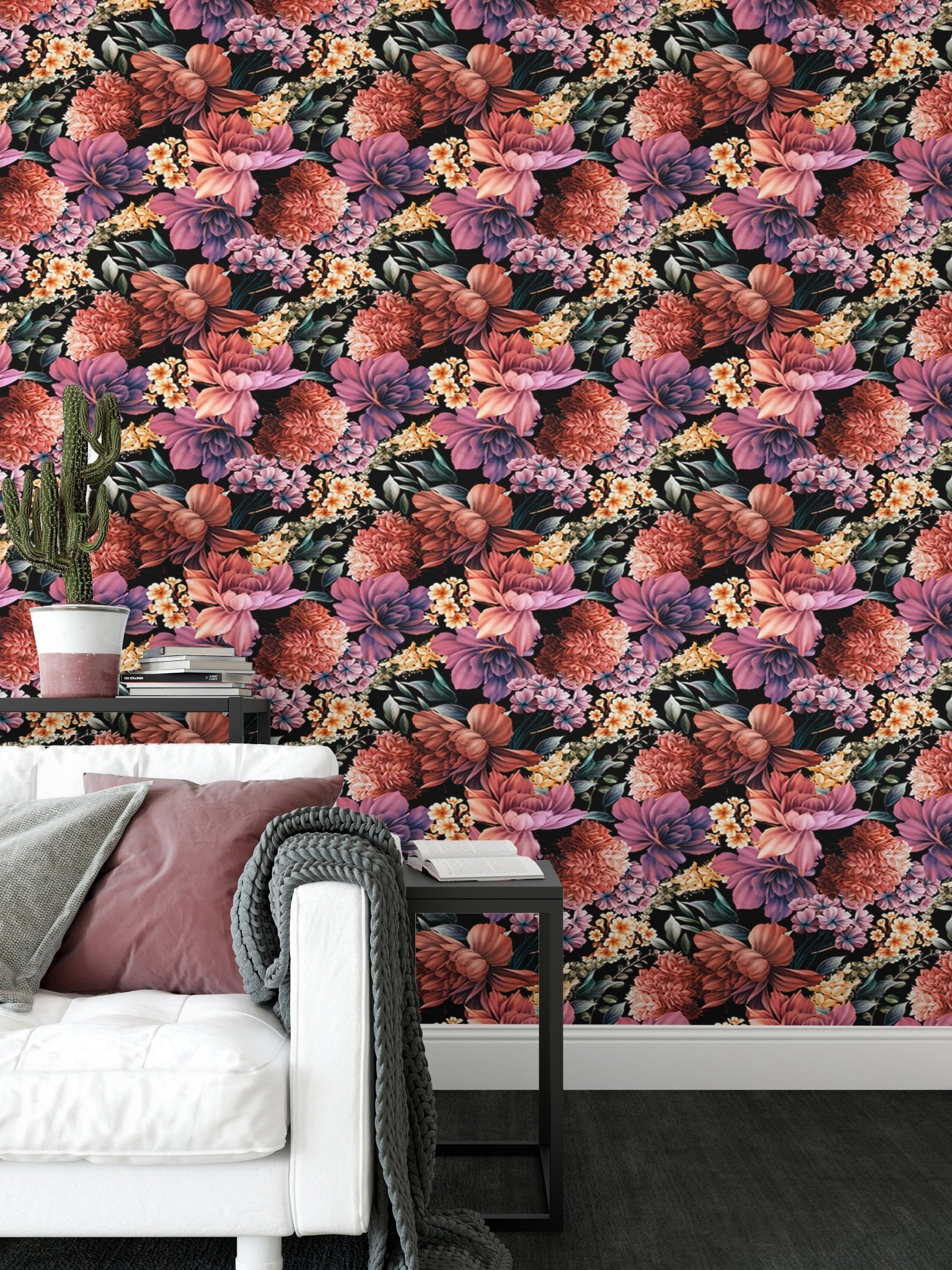 Patterned flower wallpaper behind a white sofa with grey and pink cushions.