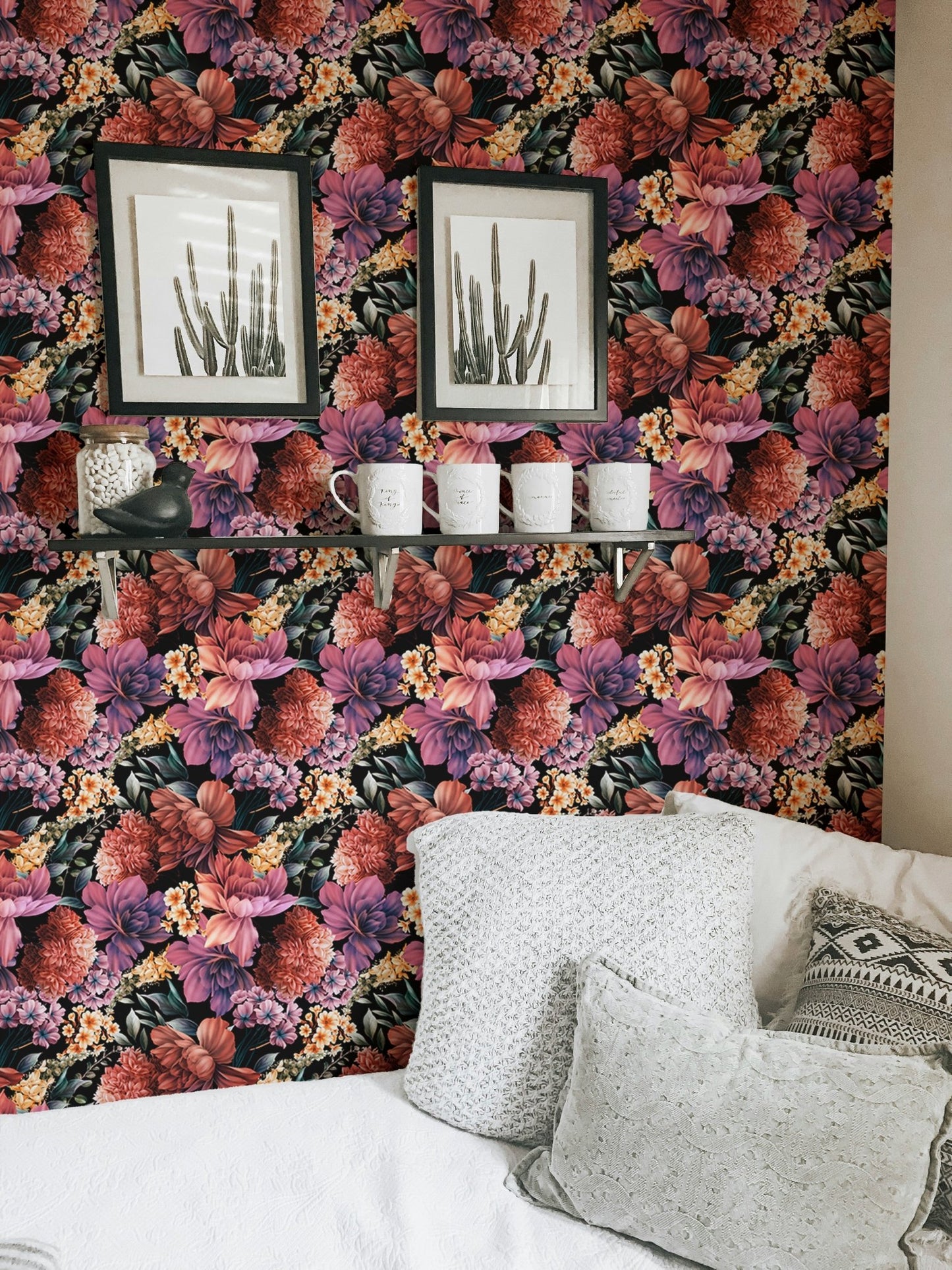 Detailed flower wallpaper in a  living room with framed wall art and white cushions.