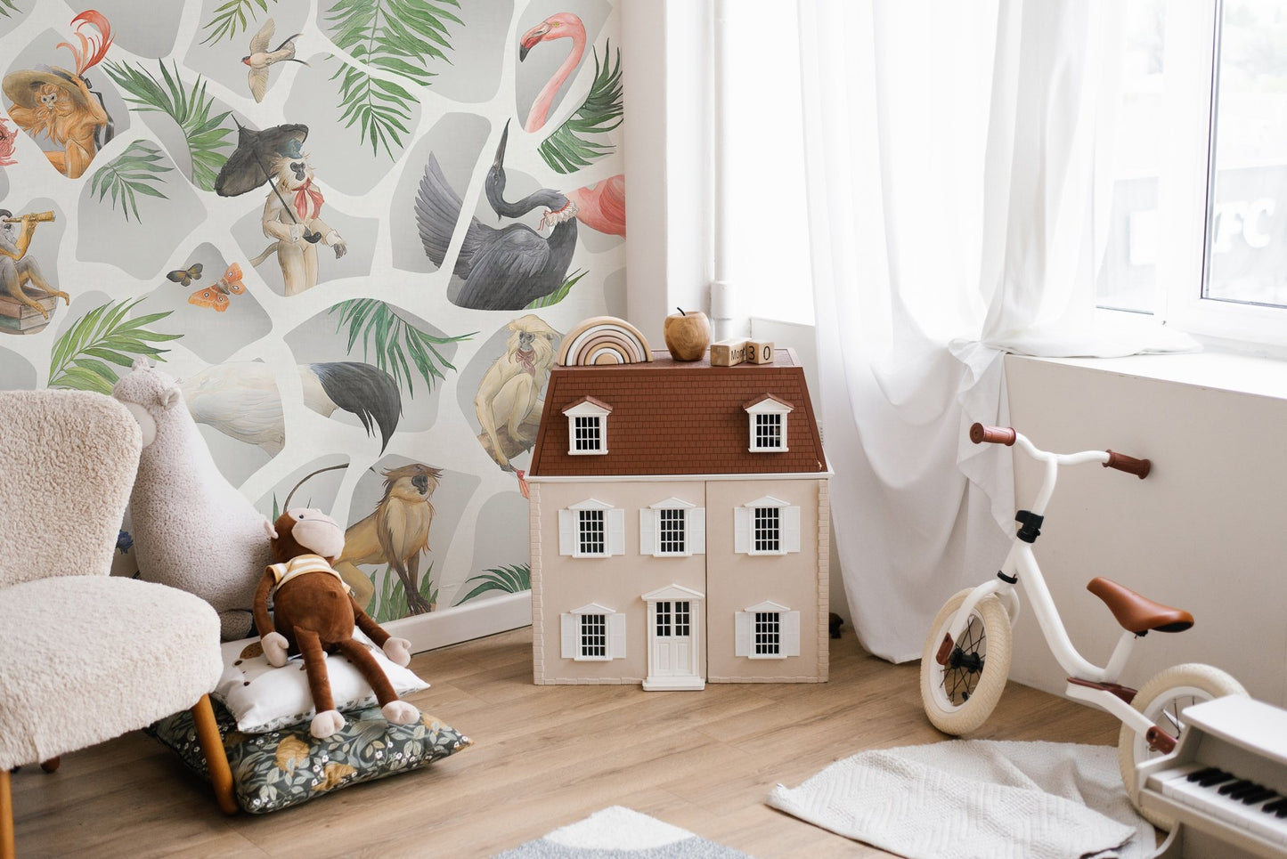 Playroom wall mural with gray monkey illustrations and a miniature dollhouse.