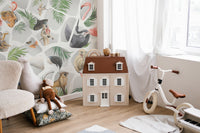 Playroom wall mural with gray monkey illustrations and a miniature dollhouse.