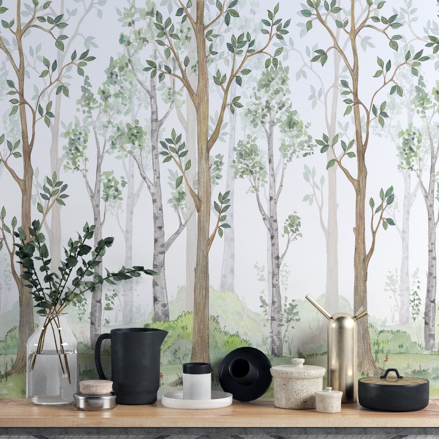 Side view of a wooden table decorated with ceramics and a forest wall mural.