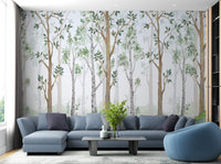 Watercolor Green Forest Wall Mural behind a blue sofa in a living room.