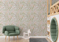Floral leaf wallpaper in a playroom featuring a green armchair and wooden toys.