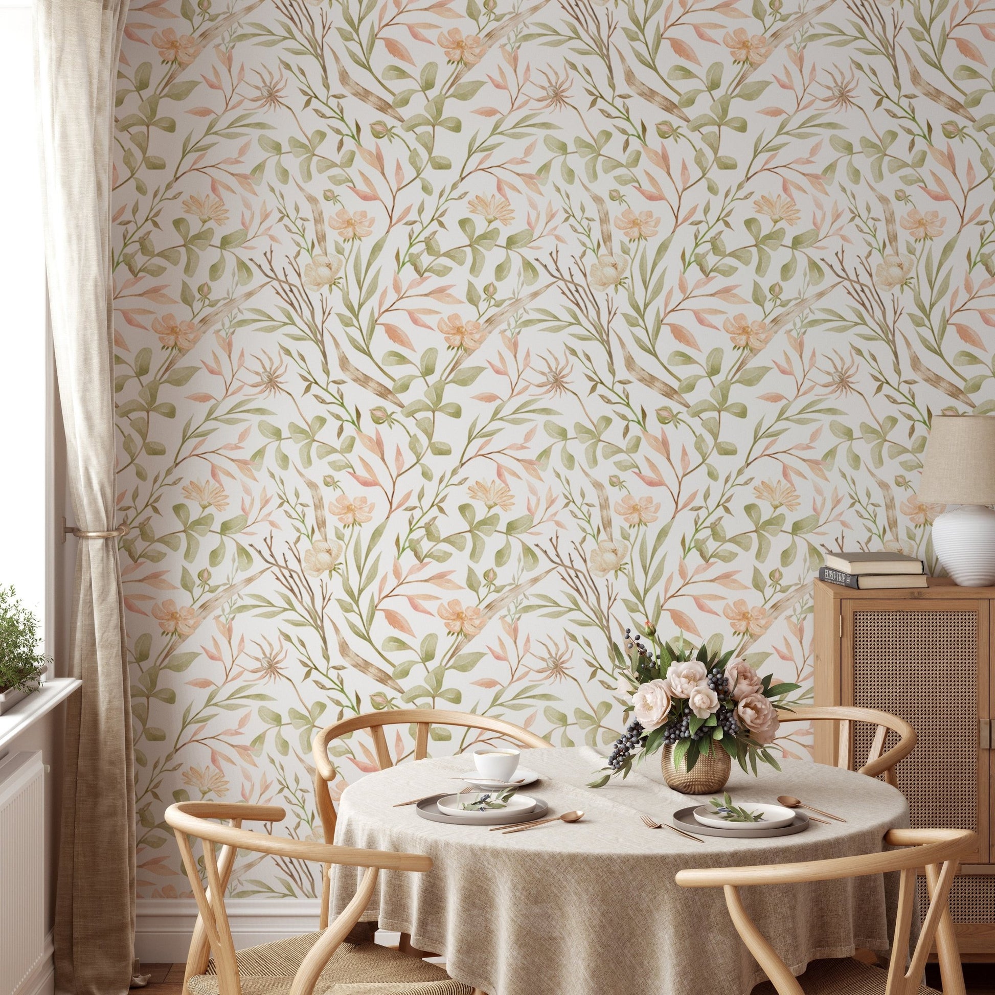 Floral meadow wallpaper behind a round dining table and wooden chairs.