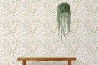 Watercolor green leaf and branches meadow flower wallpaper on a feature wall.