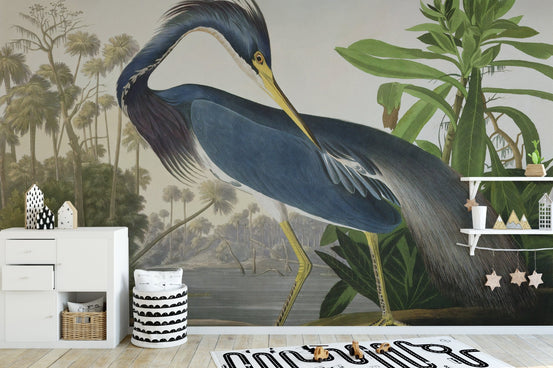 Watercolor Heron Majesty wall mural in a nursery with white storage and a patterned rug.