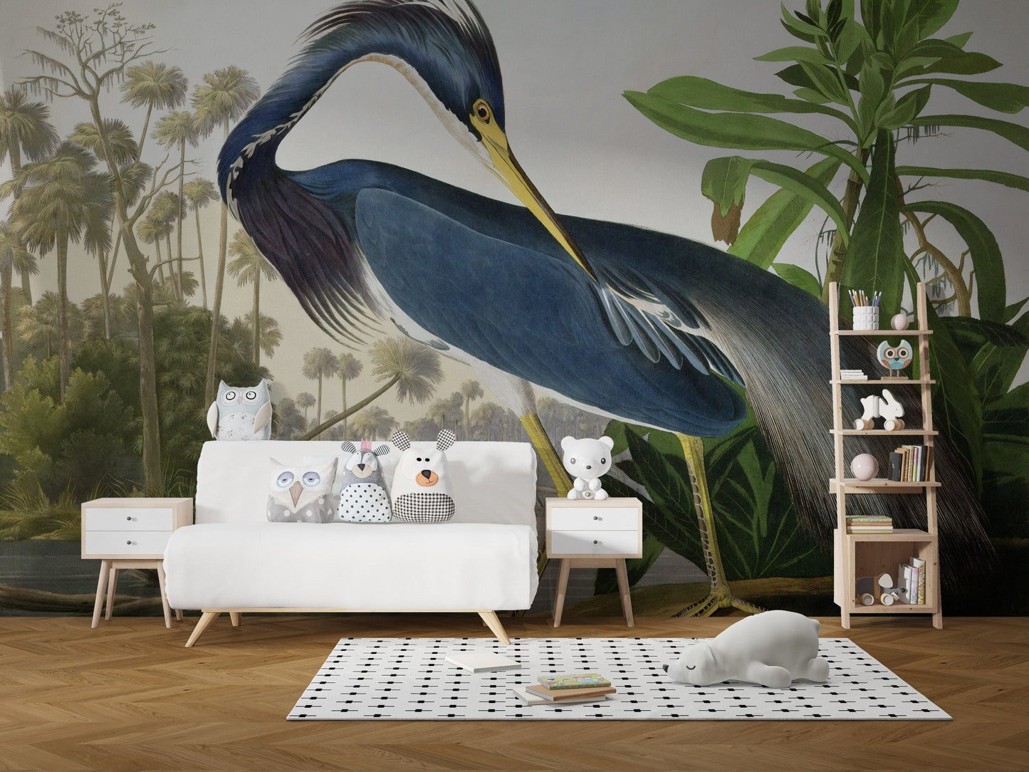 Tropical heron wall mural behind a white sofa and wooden shelving in a modern kids room.