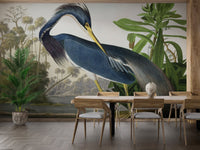 Watercolor Heron Majesty wall mural in a dining space with a dark wood table and chairs.