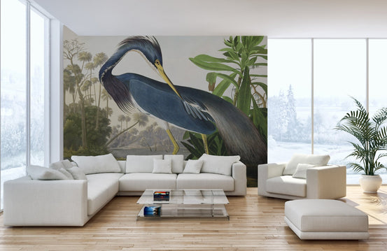 Blue heron wall mural in a large open-plan living area with a white sectional sofa.