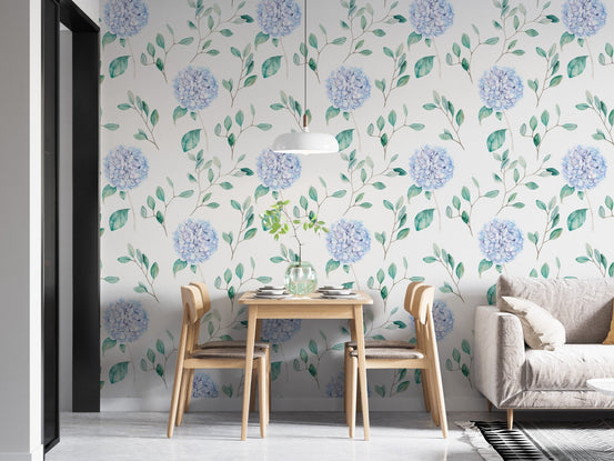 Bright dining room featuring blue flower wallpaper and light wood chairs.