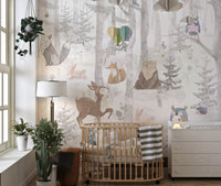 Infant nursery featuring a cot and a full wall animal forest wall mural.
