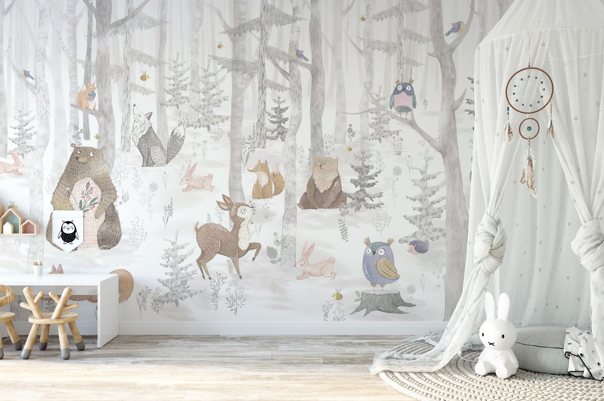 Grey and white forest animal wall mural behind a white desk in children's room.