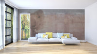 Large living room with light beige watercolor wall mural behind a white sofa.