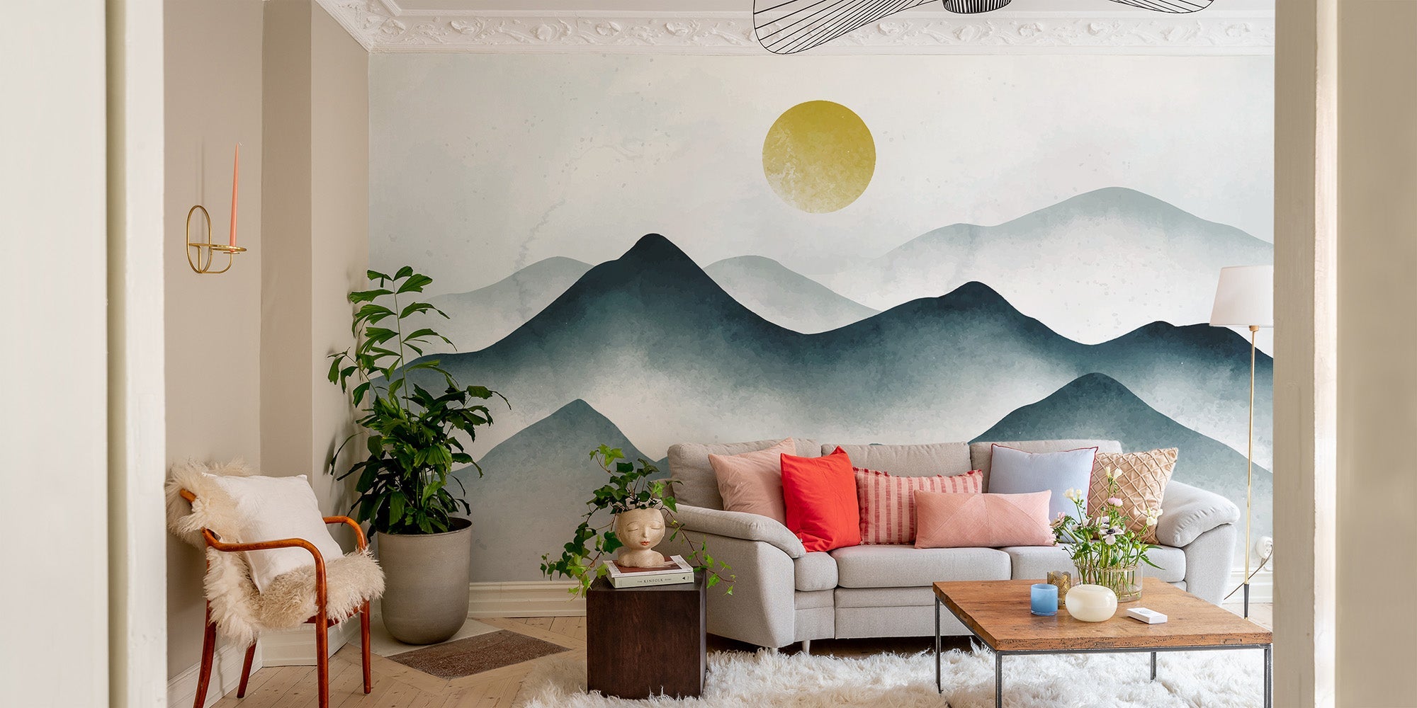 Watercolor misty mountain wallpaper with teal peaks and a golden sun disk mural.