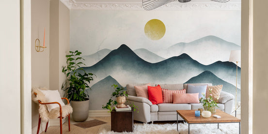 Watercolor misty mountain wallpaper with teal peaks and a golden sun disk mural.