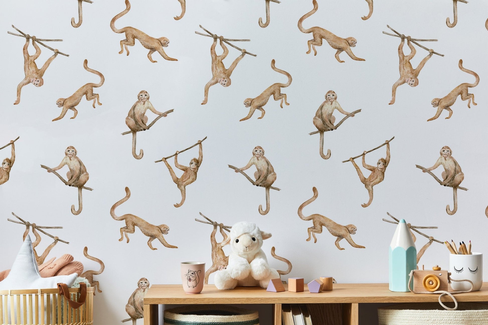 Hand-painted brown monkeys wallpaper for a neutral nursery with wooden toys.