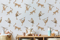 Hand-painted brown monkeys wallpaper for a neutral nursery with wooden toys.