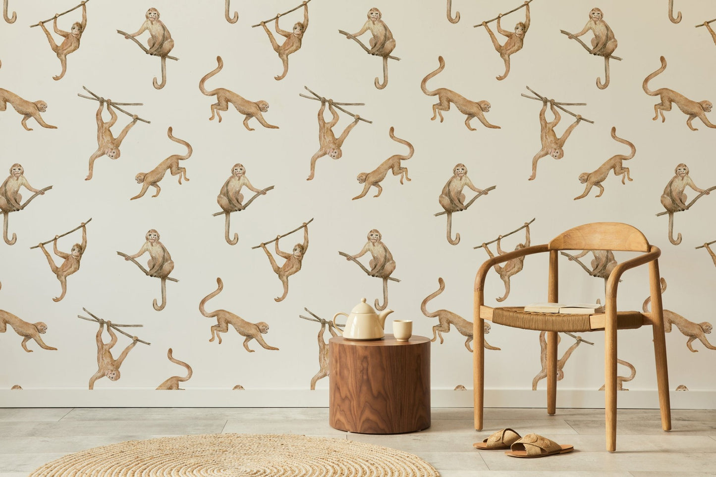 Watercolor monkeys on branches wallpaper in a sunlit room with a wooden chair.