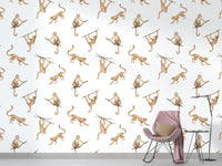 Artistic primate pattern wallpaper in a minimalist living space with a pink chair.