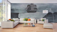 Large grey whale and wooden ship wall mural behind a white sectional sofa.