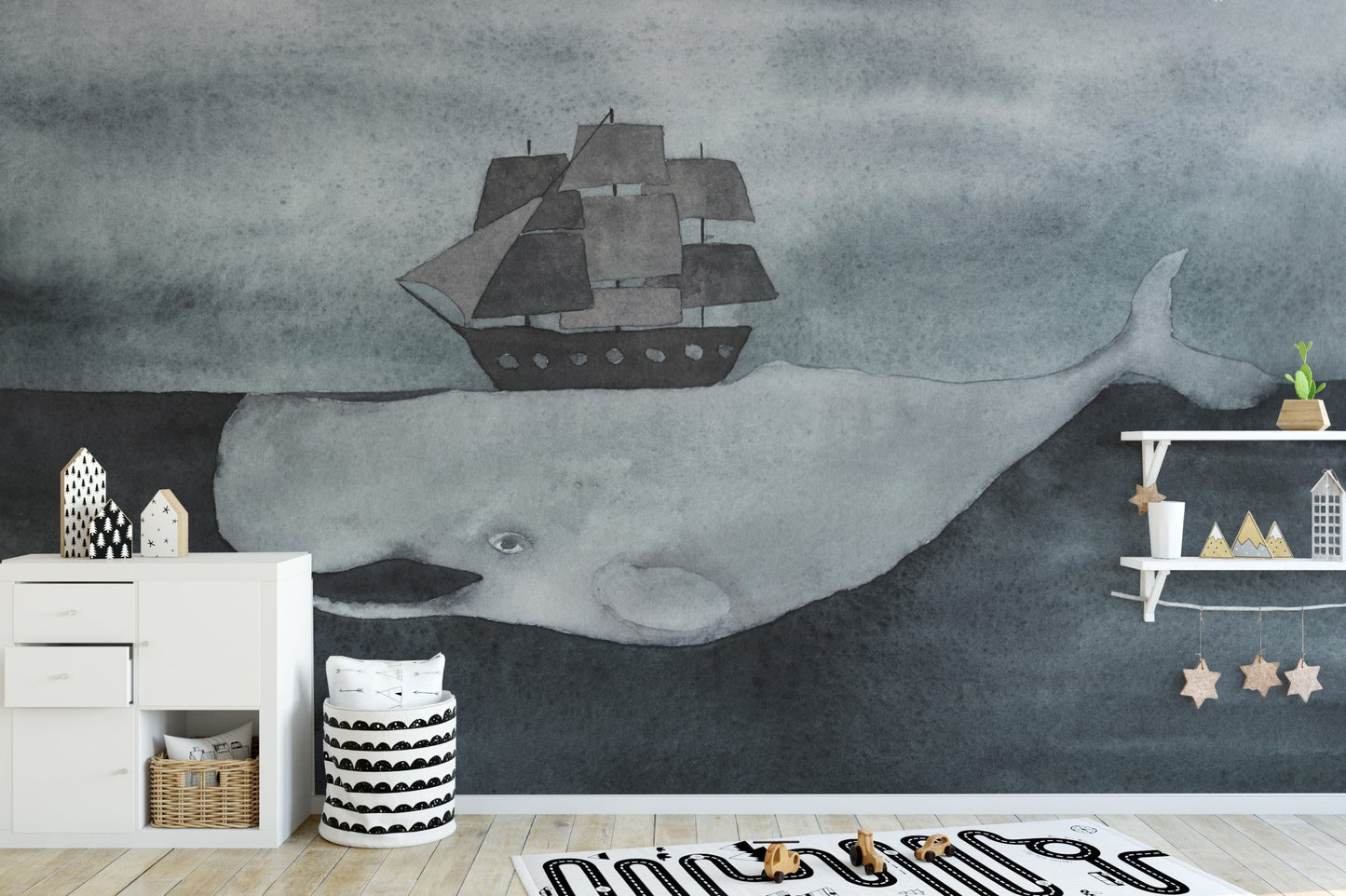 Kids playroom wall mural featuring a giant grey whale and storage cubbies.