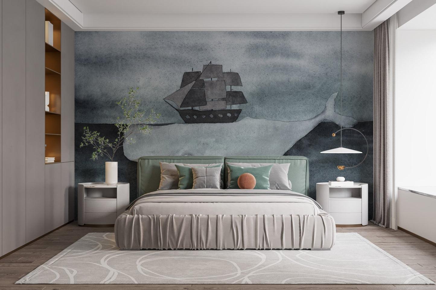 Nautical theme wall mural with a whale and ship above a grey upholstered bed.