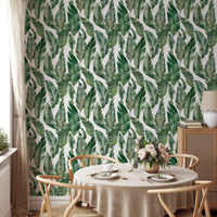 Bright dining area with Watercolor Palm Green Leaves wallpaper.