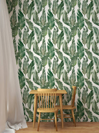 Green and white botanical wallpaper in a dining space.