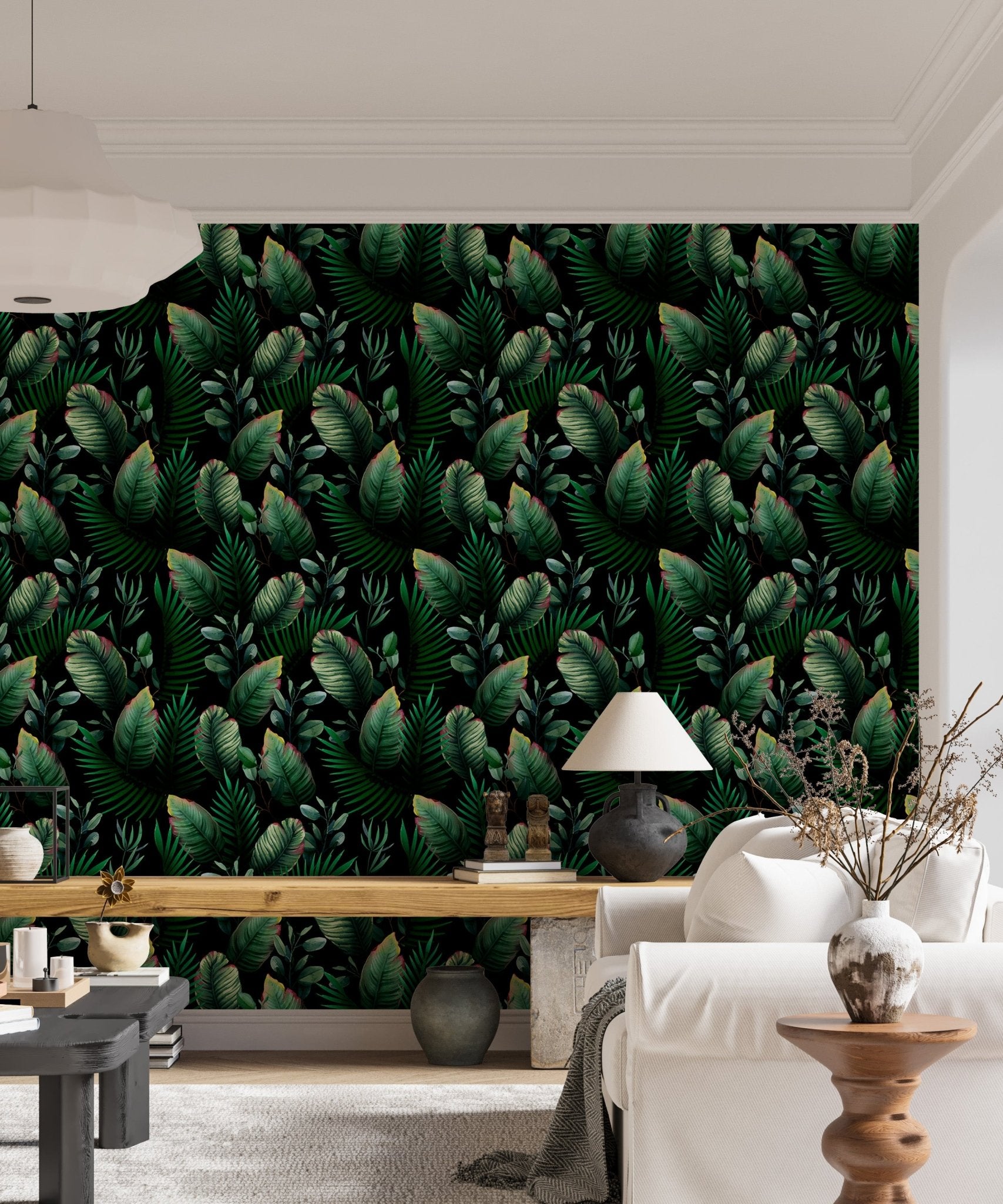 Living room sofa placed against dark green palm leaf pattern wallpaper.